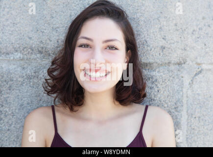 Happy laughing caucasian woman with long dark hair outdoor in the summer Stock Photo