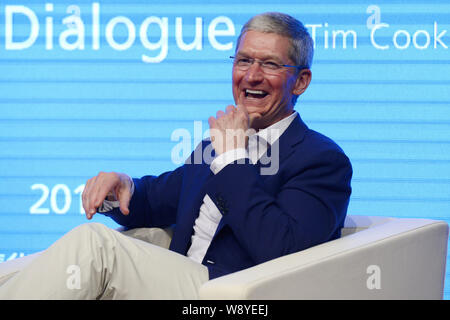 Tim Cook, CEO of Apple Inc., laughs at a dialogue with Qian Ying, dean of the School of Economics and Management (SEM), during the Tsinghua Management Stock Photo