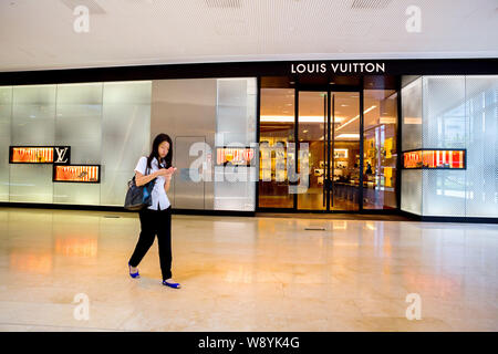 A pedestrian walks past the shop windows of the newly renovated Louis  Vuitton flagship store with decorations designed by Sarah Crowner in New  Bond Street. (Photo by Amer Ghazzal / SOPA Images/Sipa