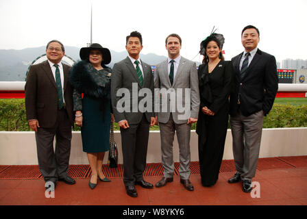 English football star Michael Owen, third right, Hong Kong singer and actor Aaron Kwok, third left, pose with other guests at the Kent & Curwen Centen Stock Photo