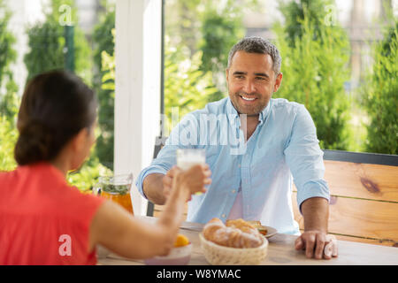 Couple feeling truly relieved enjoying breakfast outside Stock Photo