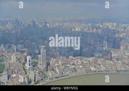 This picture taken from high in the Shanghai Tower under construction in Pudong shows a view of Huangpu River and Puxi with high-rise buildings and re Stock Photo