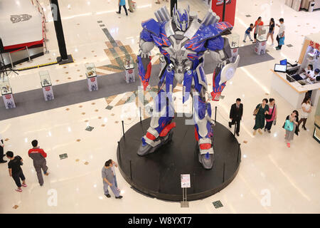 Visitors view a giant model of Optimus Prime from Hollywood movie, Transformers: Age of Extinction, during a promotional campaign for the Transformers Stock Photo