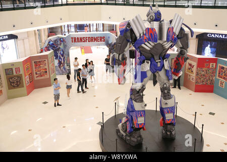 Visitors view a giant model of Optimus Prime from Hollywood movie, Transformers: Age of Extinction, during a promotional campaign for the Transformers Stock Photo