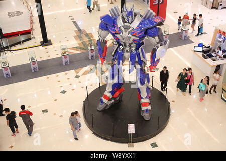 Visitors view a giant model of Optimus Prime from Hollywood movie, Transformers: Age of Extinction, during a promotional campaign for the Transformers Stock Photo