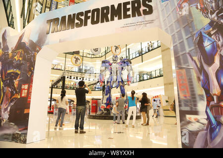 Visitors view a giant model of Optimus Prime from Hollywood movie, Transformers: Age of Extinction, during a promotional campaign for the Transformers Stock Photo