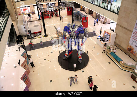 Visitors view a giant model of Optimus Prime from Hollywood movie, Transformers: Age of Extinction, during a promotional campaign for the Transformers Stock Photo