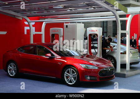 Tesla Model S electric cars to be delivered are parked at a charging station in Beijing, China, 22 April 2014.   Tesla Motors Inc. delivered its first Stock Photo