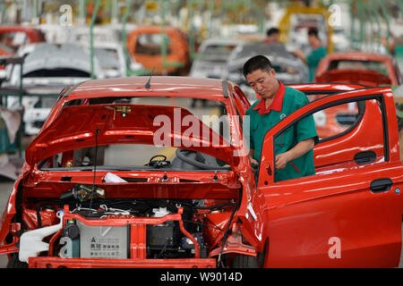 --FILE--A Chinese worker assembles a car on the assembly line at an ...