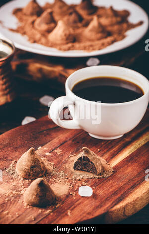 Homemade chocolate truffles coated in cocoa powder with black coffee Stock Photo
