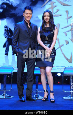 Chinese actor Feng Shaofeng, left, and actress Tang Wei pose during a press conference for their new movie, The Golden Era, in Shanghai, China, 24 Sep Stock Photo