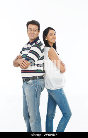 Couple standing back to back Stock Photo