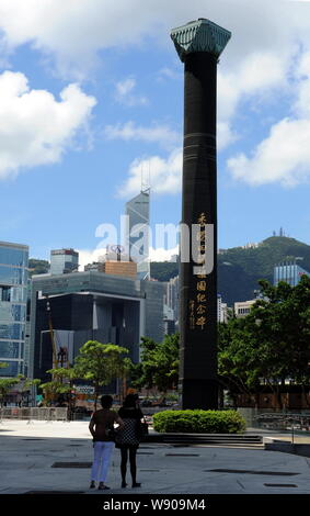 People visit the Monument in Commemoration of the Return of Hong Kong to China outside Hong Kong Convention and Exhibition Centre in Wai Chai, Hong Ko Stock Photo