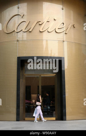 FILE A pedestrian walks past a Cartier store in Shanghai China