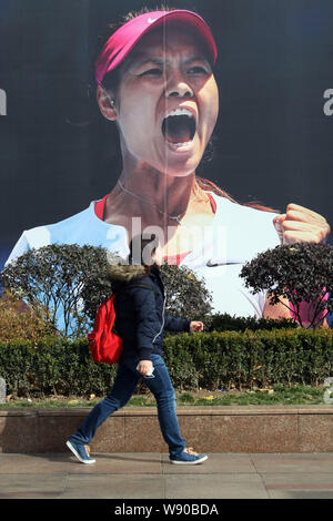 Autonomy Regulation Greenland A pedestrian walks past an advertisement of Nike with the portrait of  Chinese tennis star Li Na in Shanghai, China, 26 January 2014. Li Na is  confid Stock Photo - Alamy