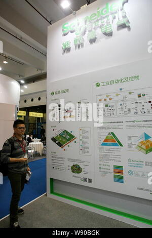 --FILE--A visitor is seen at the stand of Schneider Electric during the 1st China (Shanghai) International Technology Fair in Shanghai, China, 8 May 2 Stock Photo