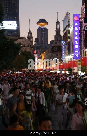 Tourists crowd the Nanjing Road shopping street on the National Day in Shanghai, China, 1 October 2014. Stock Photo