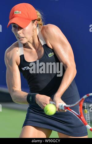 Alize Cornet of France returns a shot to Shahar Peer of Israel at their second round match of the women's singles during the 2014 WTA Guangzhou Open t Stock Photo