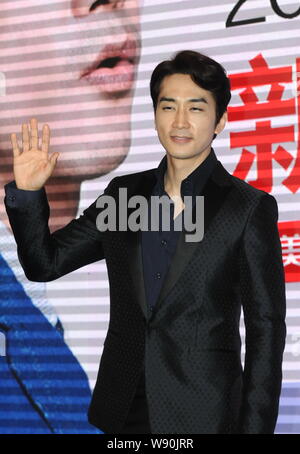 South Korean actor Song Seung-heon waves during a fan meeting in Shanghai
