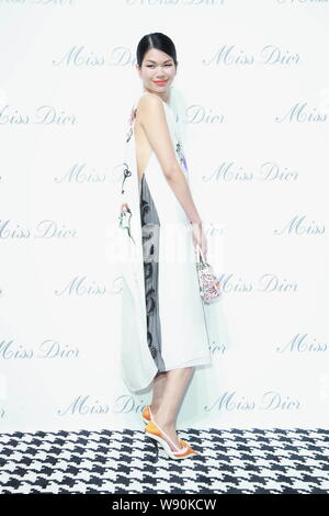 Chinese model Lv Yan poses as she arrives at the opening ceremony of the Miss Dior exhibition in Shanghai, China, 19 June 2014. Stock Photo