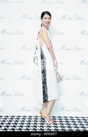 Chinese model Lv Yan poses as she arrives at the opening ceremony of the Miss Dior exhibition in Shanghai, China, 19 June 2014. Stock Photo