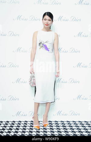 Chinese model Lv Yan poses as she arrives at the opening ceremony of the Miss Dior exhibition in Shanghai, China, 19 June 2014. Stock Photo