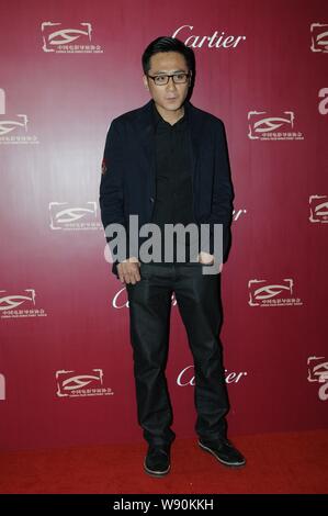 Chinese actor Liu Ye poses on the red carpet as he arrives for the nomination banquet of the 2013 China Film Directors Guide awards ceremony in Beijin Stock Photo