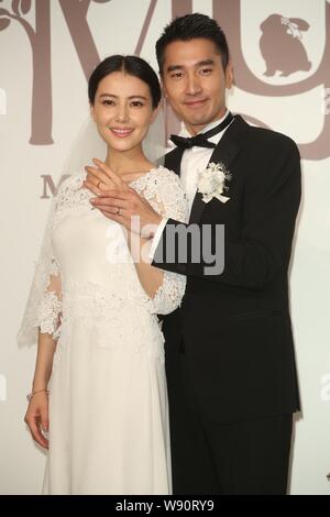 Chinese actress Gao Yuanyuan, left, and her Taiwanese actor husband Mark Chao show their wedding rings during their wedding banquet in Taipei, Taiwan, Stock Photo