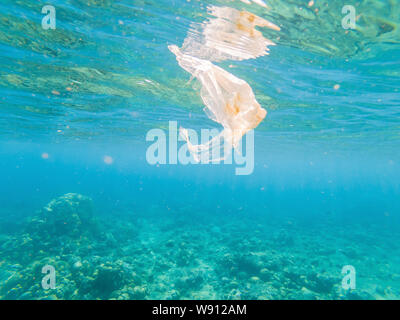 Plastic ocean. Pollution crisis as plastic bags, cups, straws and bottles end up in sea Stock Photo