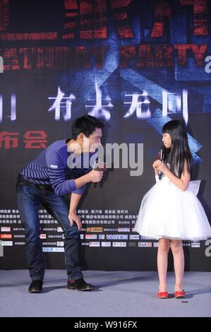 American actor Archie Kao, left, the husband of Chinese actress Zhou Xun, talks to Chinese child star Zhang Zimu during a press conference for their n Stock Photo