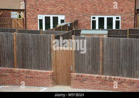 Maze of  small back gardens on a new housing estate in Kent built by Bellway Homes on a brownfield site which was a forme cement works. Stock Photo