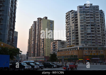 A pylon stands on the rooftop of a residential apartment building in Dazhou city, southwest Chinas Sichuan province, 17 April 2013.   A pylon mounted Stock Photo