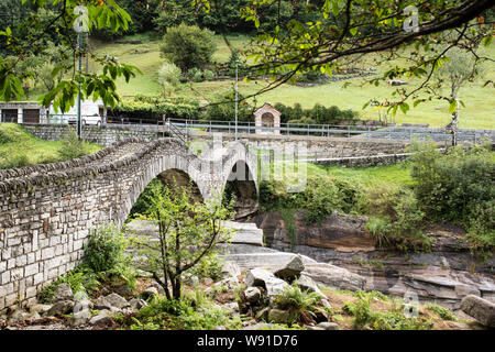 The Ponte dei Salti, a famous stone bridge over the Verzasca River in the tiny town of Lavertezzo in the Italian region of Ticino in Switzerland. Stock Photo