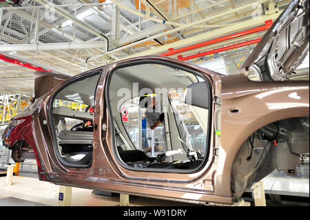 A Chinese worker assembles a Citroen car on the assembly line at the ...