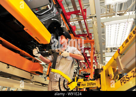 A Chinese worker assembles a Citroen car on the assembly line at the ...