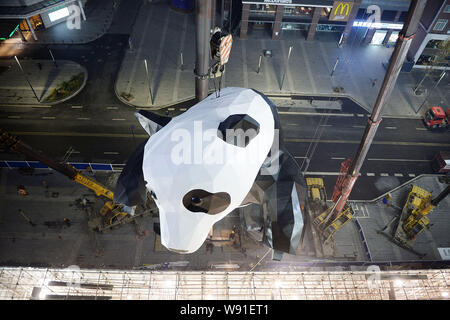 A giant panda-shaped art installation is being lifted before being installed on the facade of the Chengdu IFS shopping mall in Chengdu city, southwest Stock Photo