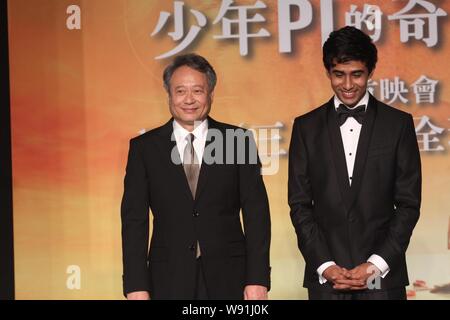 Taiwanese director Ang Lee, left, Indian actor Suraj Sharma, pose during a press conference for the 3D movie, Life of Pi, in Taipei, Taiwan, 7 Novembe Stock Photo