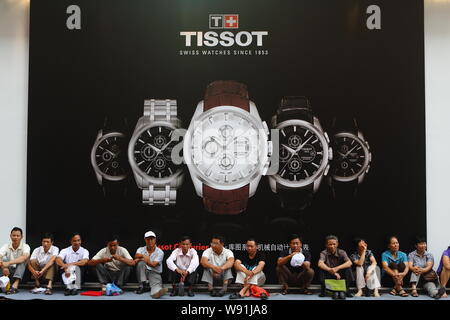 FILE Local Chinese rest in front of an advertisement of Tissot a