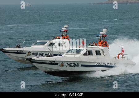 --FILE--Armed paramilitary policemen of the China Coast Guard take motorboats during a drill in Haikou city, south Chinas Hainan province, 13 July 200 Stock Photo