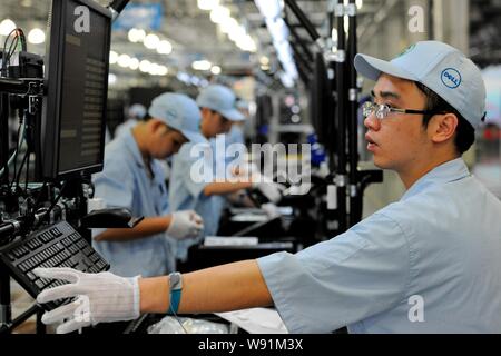 Chinese workers assemble desktop computers on the production line at ...