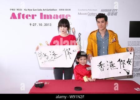 South Korean actress Ku Hye Sun, left, and Hong Kong actor Aarif Lee show their calligraphy works at the opening event for Kus solo art exhibition, Af Stock Photo