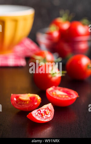 Sliced red tomatoes on black table. Stock Photo