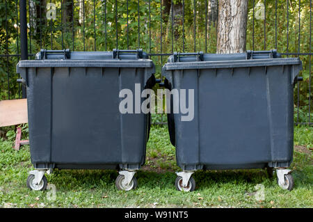 Dumpsters with lid in park. One garbage outdoor. View side Stock Photo