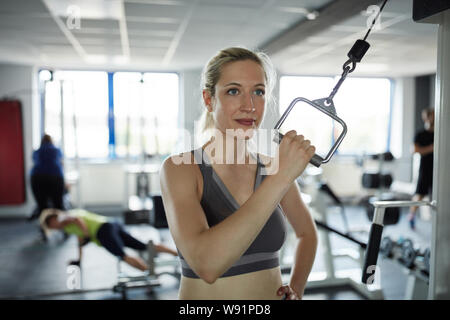 Young woman in the fitness center at the train station trains the triceps muscle Stock Photo