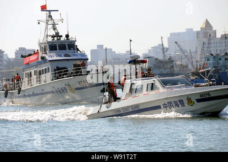 --FILE--Paramilitary policemen of the China Coast Guard take vessels to patrol the Port of Haikou in Haikou city, south Chinas Hainan province, 11 May Stock Photo