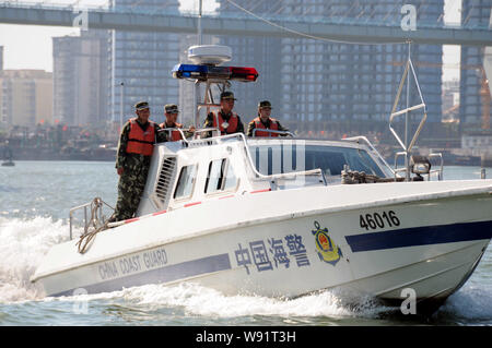 --FILE--Paramilitary policemen of the China Coast Guard take a motorboat to patrol the Port of Haikou in Haikou city, south Chinas Hainan province, 11 Stock Photo