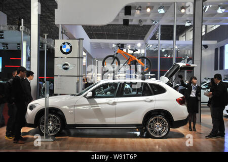 --FILE--Visitors look at a BMW X1 during an auto show in Hangzhou city, east Chinas Zhejiang province, 7 November 2012.   Bayerische Motoren Werke AG, Stock Photo