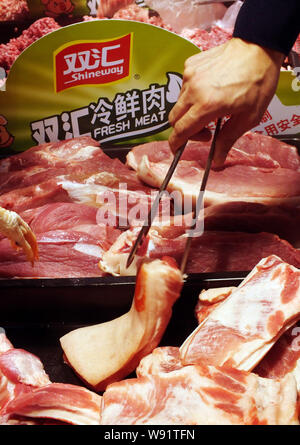 FILE--A customer buys Shineway meat sausage of Shuanghui