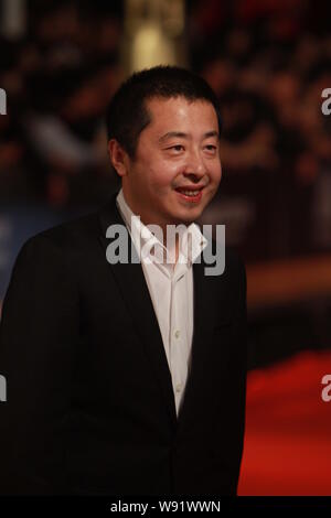 --FILE--Chinese director Jia Zhangke poses on the red carpet as he arrives for the opening ceremony of the 16th Shanghai International Film Festival i Stock Photo