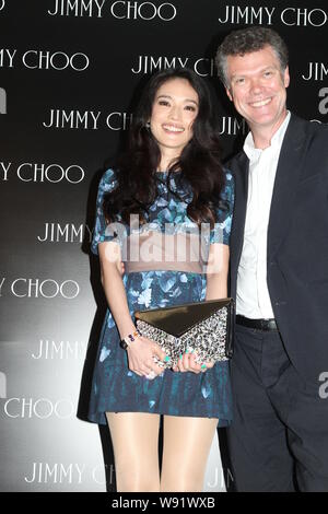 Taiwanese actress Shu Qi, left, poses as she arrives at the opening party of a new Jimmy Choo boutique in Hong Kong, China, 9 July 2013.